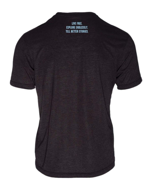 Back of black t-shirt with 'Live Free. Explore Endlessly. Tell Better Stories.' text, ideal for vanlife, overland, camper van and adventure travel enthusiasts