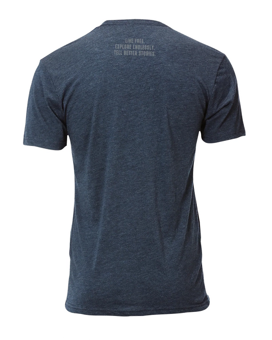 Back of heather navy t-shirt with 'Live Free, Explore Endlessly, Tell Better Stories' text, ideal for vanlife and overland adventure travel.