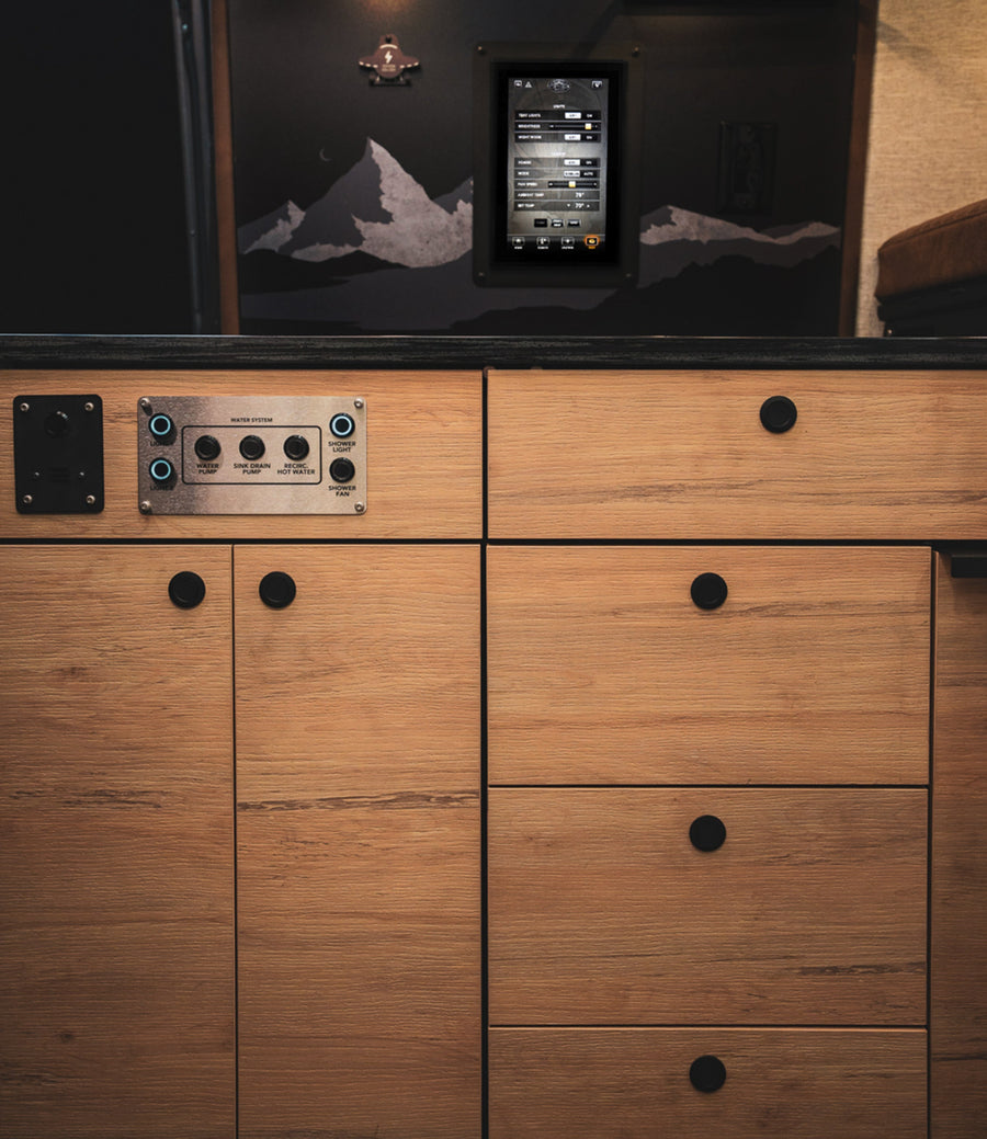 Camper van interior control panel and touch screen, modern cabinetry, overland adventure van.