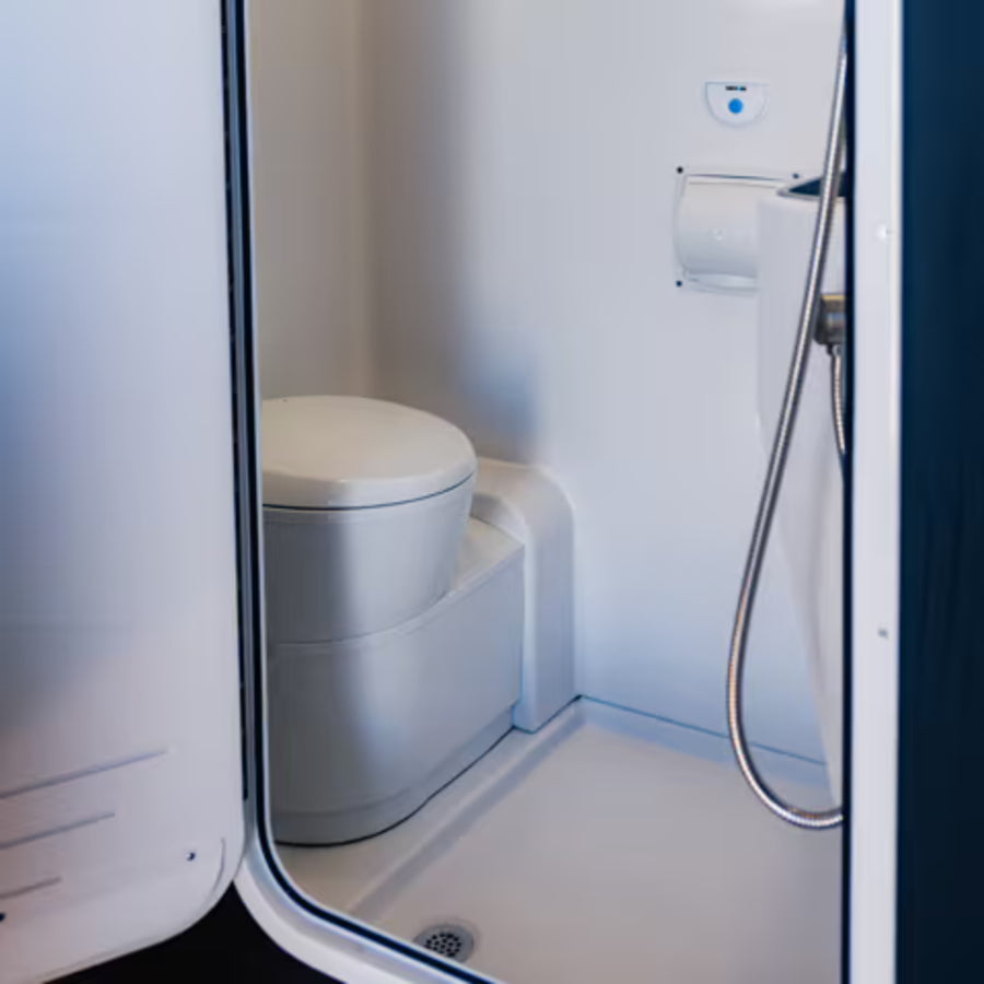 Camper van wet bath interior with toilet and shower, ideal for overland and vanlife travel
