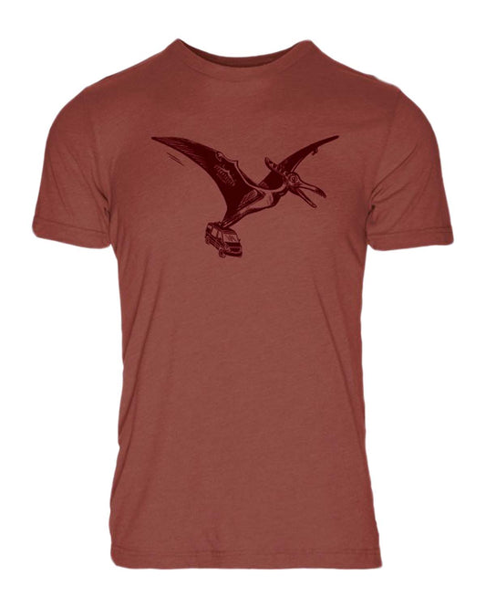 Rust-colored t-shirt with a graphic of a pterodactyl carrying a camper van, adventure van art